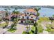 Waterfront home with lush landscaping, a tile roof, and large driveway provides curb appeal at 16327 Redington Dr, Redington Beach, FL 33708