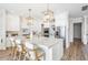 Bright, modern kitchen with stainless appliances, white cabinets and countertops, and an oversized island at 16327 Redington Dr, Redington Beach, FL 33708