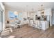 Well-lit, modern kitchen with stainless steel appliances, a center island, and adjacent dining area at 16327 Redington Dr, Redington Beach, FL 33708