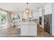 Bright open-concept kitchen with island, stainless appliances, and adjacent dining area with water views at 16327 Redington Dr, Redington Beach, FL 33708