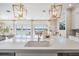 Bright kitchen with island, quartz countertops, stainless steel appliances, and views of water at 16327 Redington Dr, Redington Beach, FL 33708