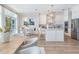 Modern kitchen with stainless steel appliances, white cabinetry, and dining area with waterfront views at 16327 Redington Dr, Redington Beach, FL 33708
