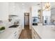 Modern kitchen with white cabinetry, stainless appliances, gas range, and quartz countertops at 16327 Redington Dr, Redington Beach, FL 33708