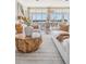 Cozy living room with a patterned rug, a geometric coffee table, modern seating and natural lighting at 16327 Redington Dr, Redington Beach, FL 33708
