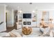 A comfortable living room with built-in shelving, a modern fireplace, and stylish, neutral-toned furniture at 16327 Redington Dr, Redington Beach, FL 33708
