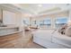 Bright main bedroom boasts hardwood floors, recessed lighting, and a view of the water at 16327 Redington Dr, Redington Beach, FL 33708