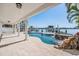 Backyard with a pool, spa, boat lift, and covered patio at 16327 Redington Dr, Redington Beach, FL 33708