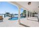 Backyard with a pool, spa, boat lift, and covered patio at 16327 Redington Dr, Redington Beach, FL 33708
