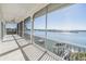 Screened porch offering waterfront views, neutral tile, and white columns at 16327 Redington Dr, Redington Beach, FL 33708