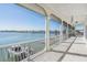 Screened porch with waterfront views, white columns, and boat dock at 16327 Redington Dr, Redington Beach, FL 33708