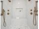 Luxurious marble shower with dual shower heads, a built-in bench, and toiletry niche at 16327 Redington Dr, Redington Beach, FL 33708