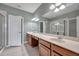 Bathroom featuring dual sinks with a large mirror, tile floor, and walk-in glass enclosed shower at 2028 Kings Palace Dr # 202, Riverview, FL 33578
