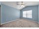 Bright bedroom with vaulted ceilings, carpeted floor and large window at 2028 Kings Palace Dr # 202, Riverview, FL 33578