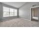 Well-lit bedroom with neutral walls, plush carpet, and a large window for natural light at 2028 Kings Palace Dr # 202, Riverview, FL 33578