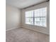 Bedroom features a large window, neutral walls, and carpeted flooring at 2028 Kings Palace Dr # 202, Riverview, FL 33578