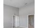 Bedroom with neutral-colored walls and carpeted floors, leading to a bathroom with a glass-enclosed shower at 2028 Kings Palace Dr # 202, Riverview, FL 33578