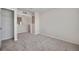 Bright bedroom featuring neutral walls, plush carpet, and a convenient closet at 2028 Kings Palace Dr # 202, Riverview, FL 33578