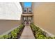 Inviting entrance with manicured landscaping leading to the front doors and natural lighting at 2028 Kings Palace Dr # 202, Riverview, FL 33578