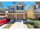Inviting two-story townhouse featuring a two-car garage and well-maintained landscaping at 2028 Kings Palace Dr # 202, Riverview, FL 33578