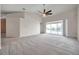 Spacious living room with vaulted ceilings, ceiling fan, and sliding glass doors to the outside at 2028 Kings Palace Dr # 202, Riverview, FL 33578