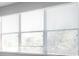 Bright room featuring a bank of sunlit windows with modern blinds at 2028 Kings Palace Dr # 202, Riverview, FL 33578