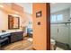 Bathroom with glass shower, soaking tub, wood flooring and modern fixtures at 2112 Laurence Dr, Clearwater, FL 33764
