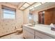 Functional bathroom features vintage wallpaper and fixtures at 2112 Laurence Dr, Clearwater, FL 33764