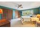 Large bedroom with a ceiling fan, large window overlooking the backyard, and double closets at 2112 Laurence Dr, Clearwater, FL 33764