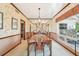 Traditional dining room with wood table, chairs, chandelier, and floral wallpaper at 2112 Laurence Dr, Clearwater, FL 33764
