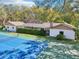 Rear exterior view of home showing tennis court, screened-in pool and lanai at 2112 Laurence Dr, Clearwater, FL 33764