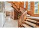 Spacious foyer with wooden staircase and paneled accent wall at 2112 Laurence Dr, Clearwater, FL 33764