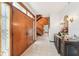 Spacious foyer featuring tile floors, a wooden staircase, and elegant decor at 2112 Laurence Dr, Clearwater, FL 33764