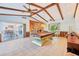 Spacious game room features a pool table, stone fireplace, and access to outdoor areas at 2112 Laurence Dr, Clearwater, FL 33764