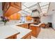 Bright kitchen with white countertops, light wood cabinets and an island, plus a ceiling fan at 2112 Laurence Dr, Clearwater, FL 33764