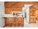 Kitchen bar with wood cabinetry and an open design with a view to the kitchen in the back at 2112 Laurence Dr, Clearwater, FL 33764