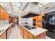 Spacious kitchen with wood cabinets, white countertops, and black appliances, plus a large hood at 2112 Laurence Dr, Clearwater, FL 33764