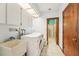 Convenient laundry room features sink, washer, dryer, and storage cabinets at 2112 Laurence Dr, Clearwater, FL 33764