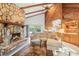 Comfortable living room with a stone fireplace, vaulted ceilings, and access to the kitchen at 2112 Laurence Dr, Clearwater, FL 33764