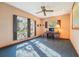 This office has blue carpet, shutters on the windows, a ceiling fan, and a desk for a nice work area at 2112 Laurence Dr, Clearwater, FL 33764