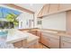 This home features an outdoor kitchen with countertop, sink, cabinets, and bar at 2112 Laurence Dr, Clearwater, FL 33764