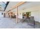 Outdoor covered patio with brick flooring, seating, dining area and a view of the pool at 2112 Laurence Dr, Clearwater, FL 33764