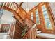 Unique staircase with stained glass windows and a wooden banister gives access to the second floor at 2112 Laurence Dr, Clearwater, FL 33764