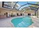 Screened-in backyard swimming pool with ample patio space for dining and lounging at 2112 Laurence Dr, Clearwater, FL 33764