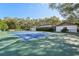 A private tennis court is part of the large backyard and adjacent to the home at 2112 Laurence Dr, Clearwater, FL 33764
