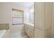 Bright bathroom with a vanity, a storage cabinet, and a window with wood blinds at 2121 Park N St, St Petersburg, FL 33710