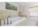 Relaxing bathroom featuring a tub with tile surround and a window with wood blinds at 2121 Park N St, St Petersburg, FL 33710