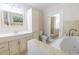 Well-lit bathroom featuring a jacuzzi tub, a large vanity, and a separate toilet area at 2121 Park N St, St Petersburg, FL 33710