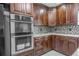 Close up of kitchen featuring stainless steel oven, granite counters, and mosaic backsplash at 2121 Park N St, St Petersburg, FL 33710