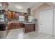 Charming kitchen with stainless appliances, dark wood cabinets, granite countertops, and a convenient kitchen island at 2121 Park N St, St Petersburg, FL 33710