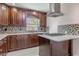 This renovated kitchen showcases rich wood cabinetry, granite counters, a modern range hood, and an eye-catching backsplash at 2121 Park N St, St Petersburg, FL 33710